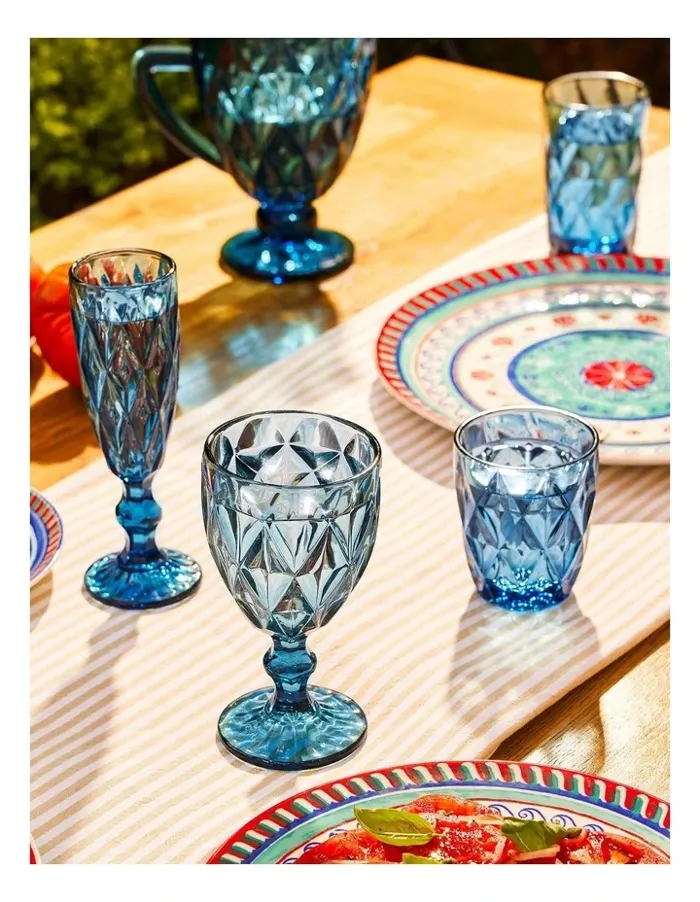 Blue glassware arranged on a colourful outdoor table